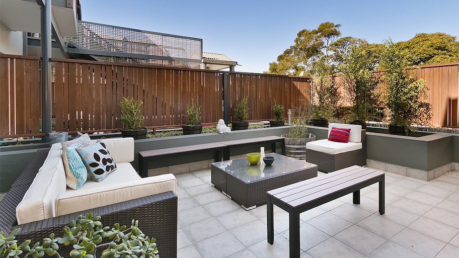 backyard patio with secluded wooden fence      